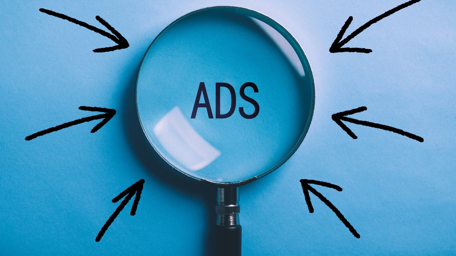 Magnifying glass highlighting the word ADS, representing Google Ads budget planning